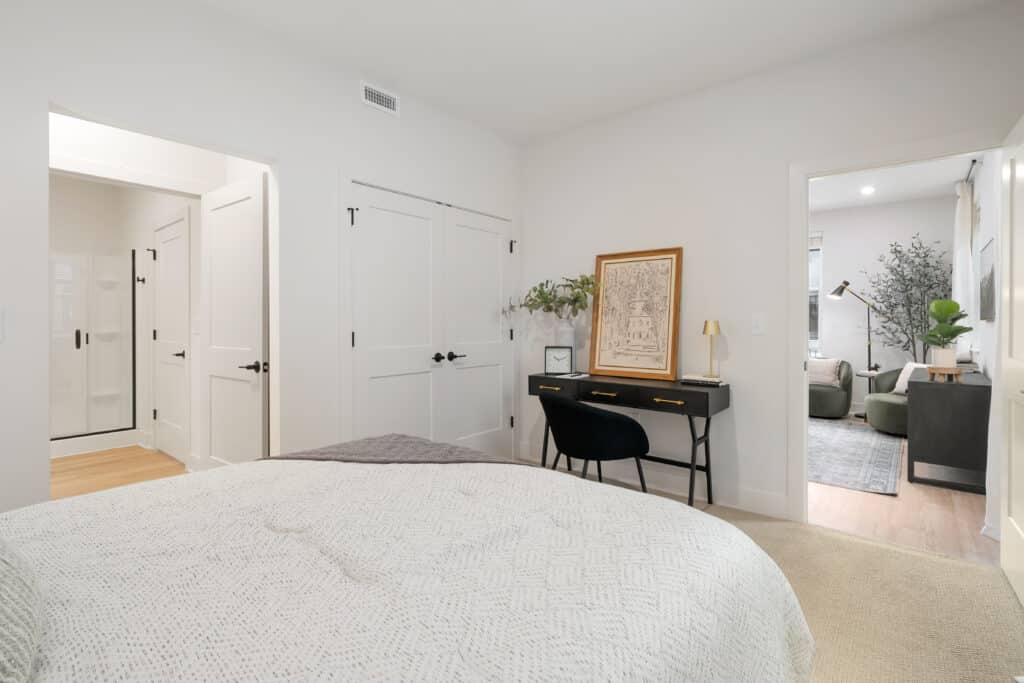 A cozy one bedroom apartment featuring a comfortable bed and a functional desk for work or study.